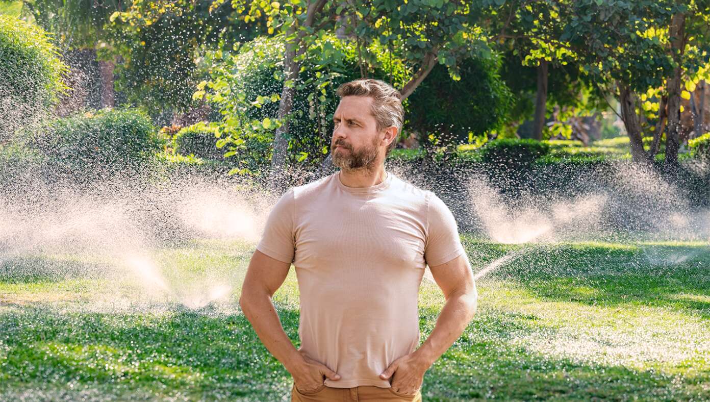 Like Genghis Khan Gazing Over His Empire, Man Watches As Fixed Sprinkler No Longer Waters Driveway - Article image