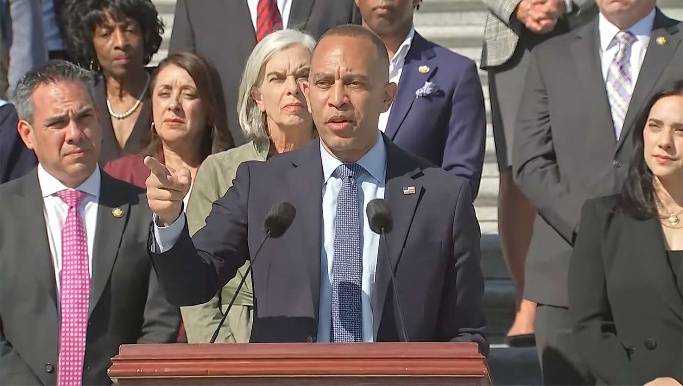 House Minority Leader Hakeem Jeffries giving a speech in front of Democratic members of Congress.